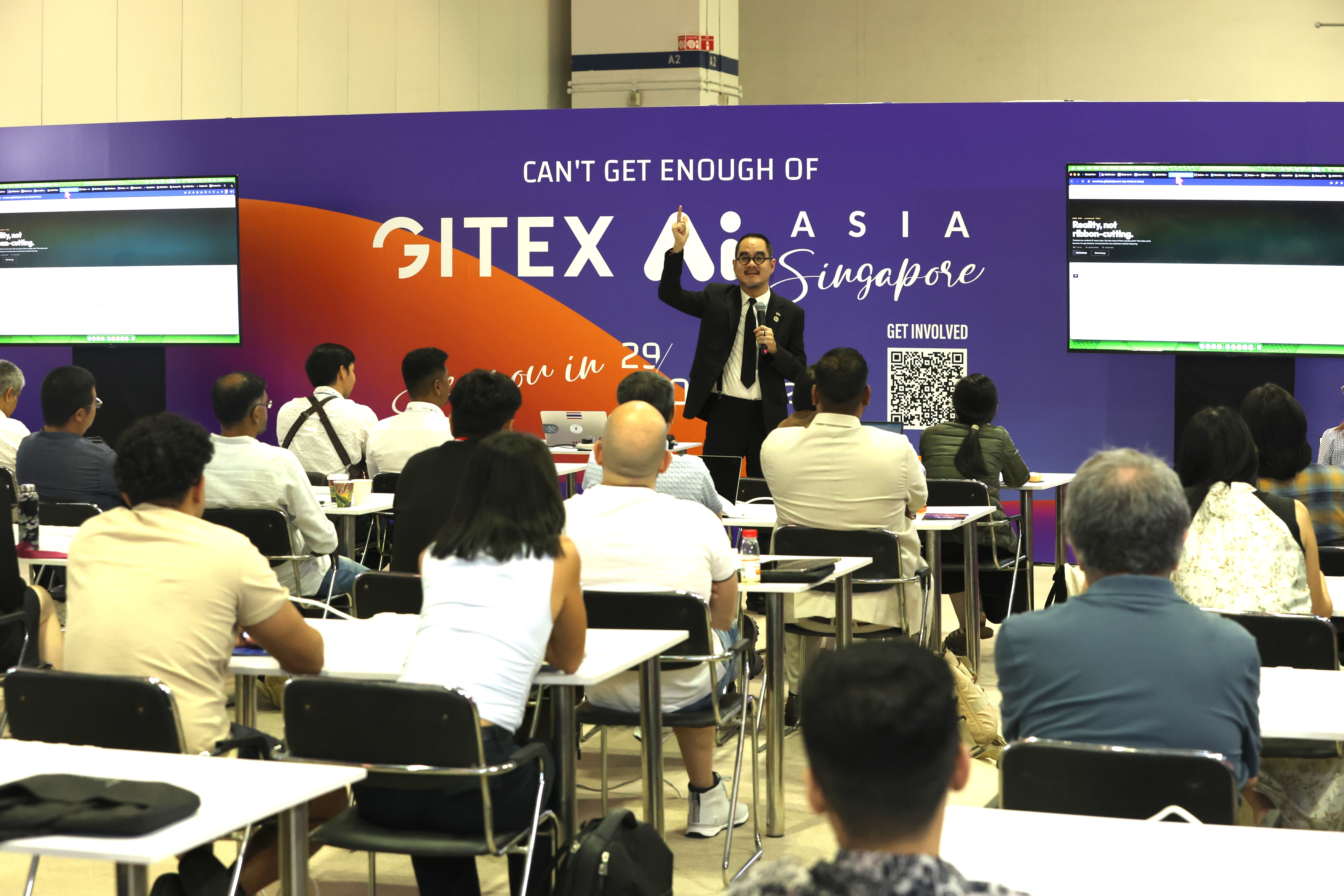 Dr. Non on the main stage at GITEX Asia 2026 Singapore, with Smart City Thailand and SLIC Index as tech partners